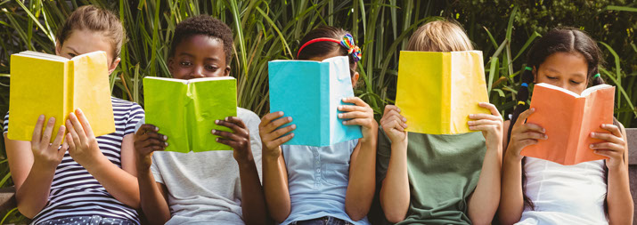 children reading books in a row