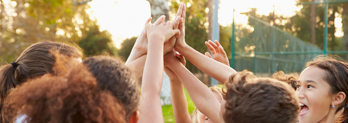 children high fiving each other